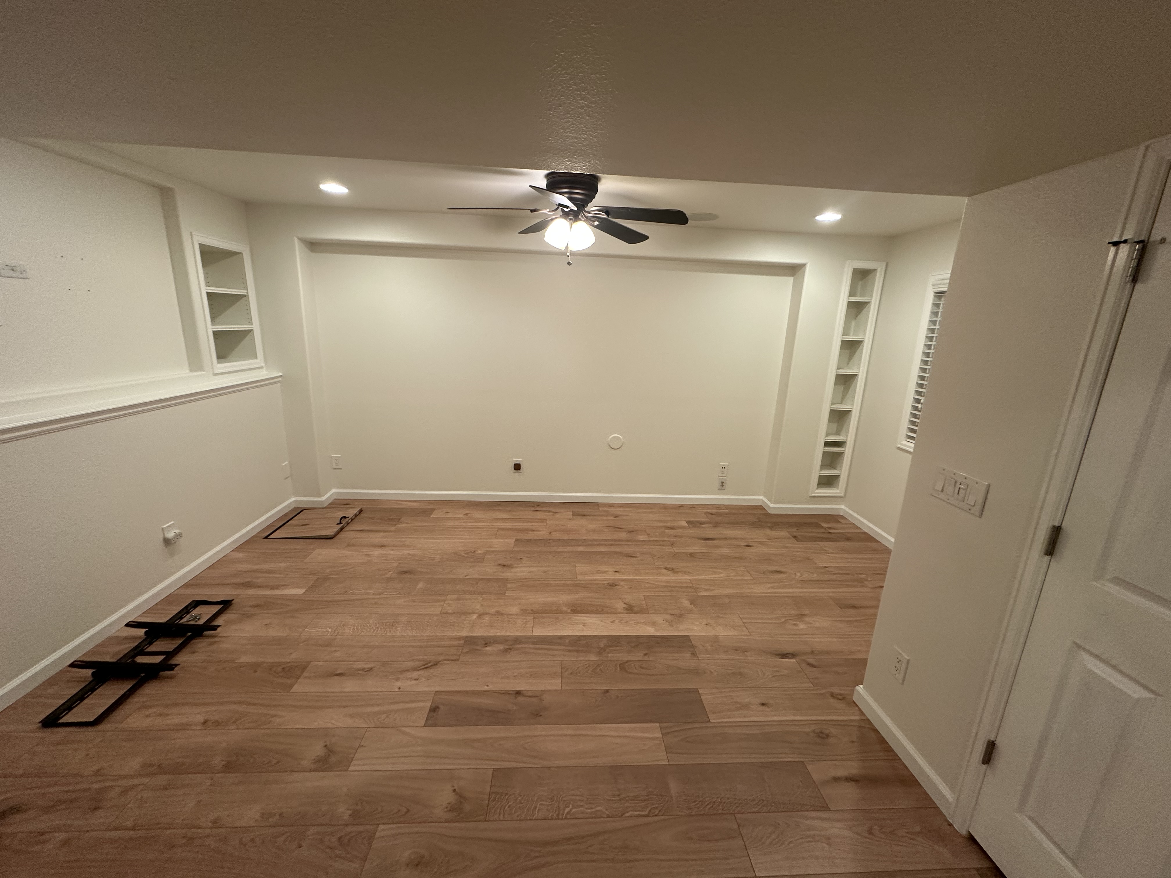 Finished Basement Room - White Walls and Wood Flooring